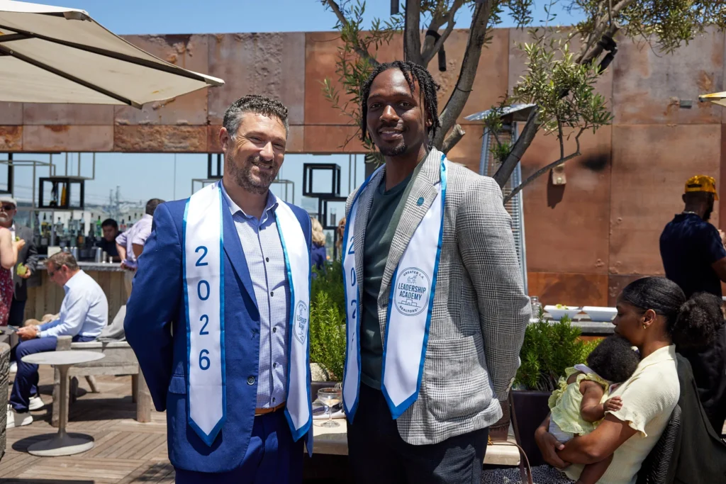 Two Leadership Academy graduates wearing 2026 sashes