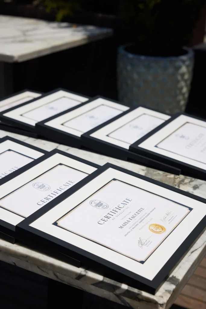 Framed Leadership Academy certificates on a table